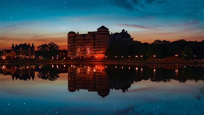 Building reflection on water under starry sunset sky 4K