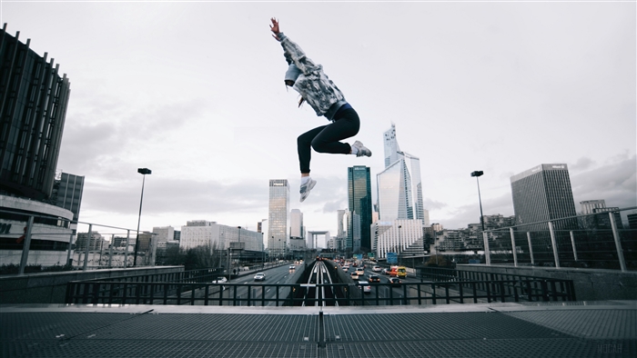 Person jumping over highway in city 4K