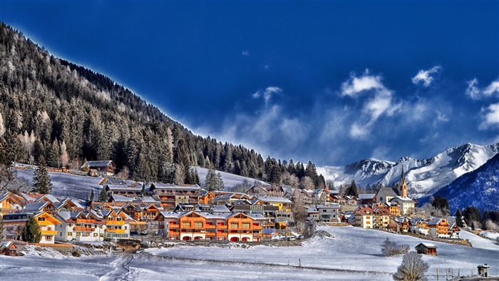 Winter village in the Alps with snow-covered mountains