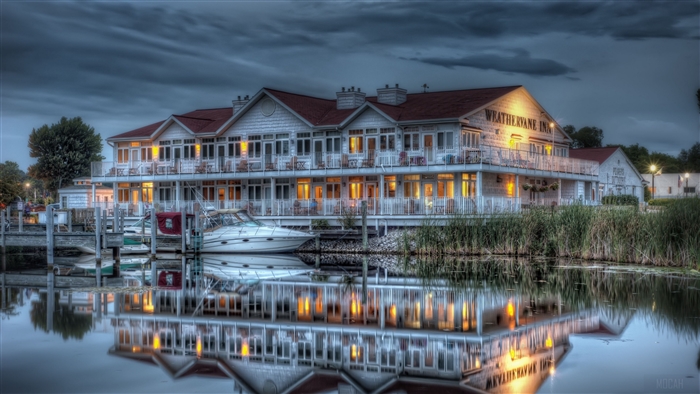 Weathervane Inn on a river at dusk