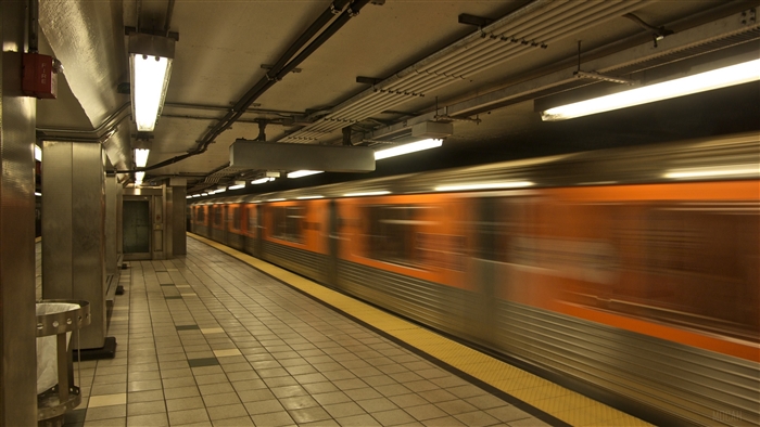 Subway train in motion at underground station