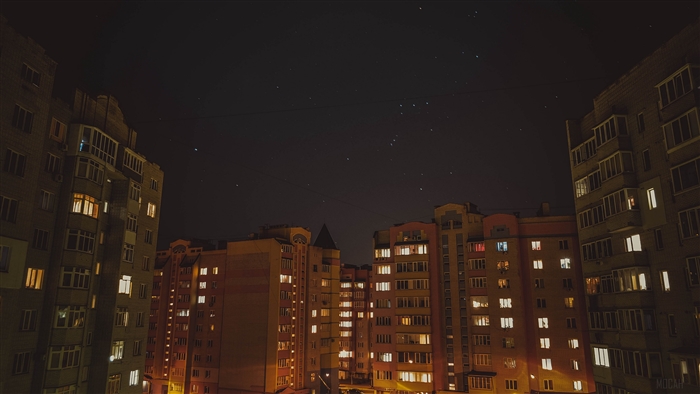 Apartment buildings at night with stars