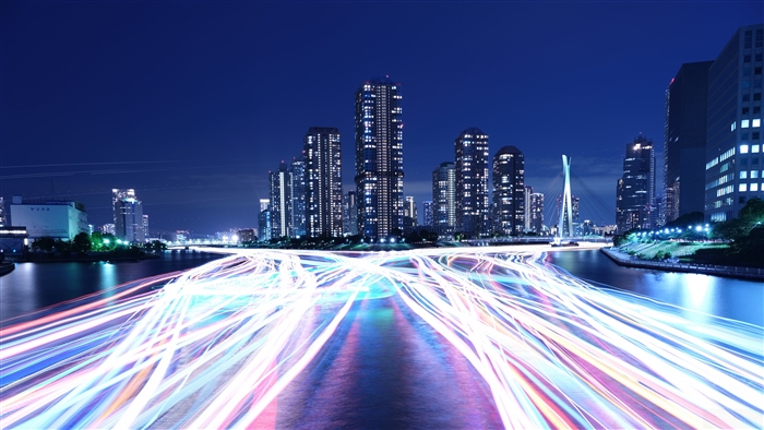 Night city skyline with light trails on river