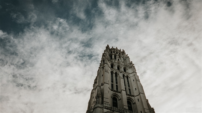 Gothic architecture tower against a cloudy sky