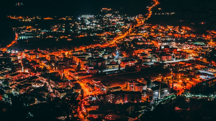 Aerial view of a city at night with glowing lights