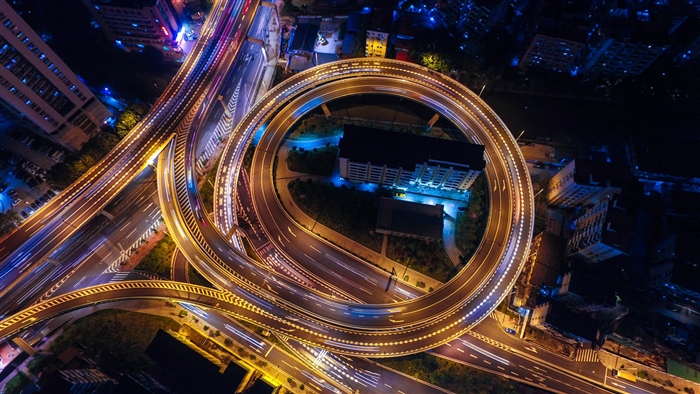 Aerial view of a busy traffic junction at night in 4K