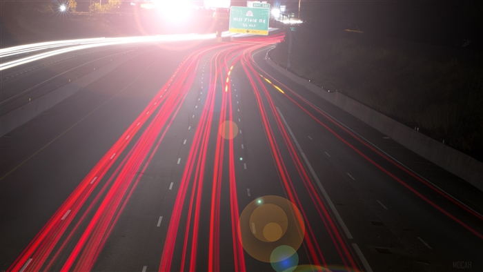 Highway Light Trails with Exit Sign