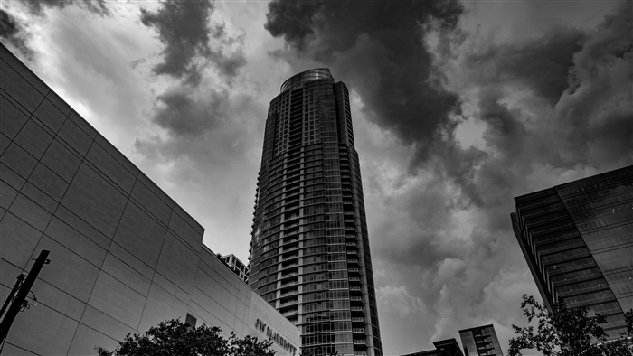 Skyscraper facade with clouds in black and white 4K