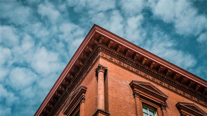 Brick building corner against blue sky 4K