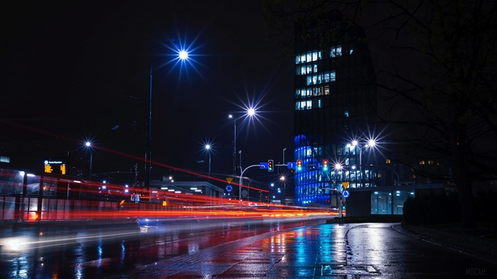 Night city street with light trails and buildings 4K