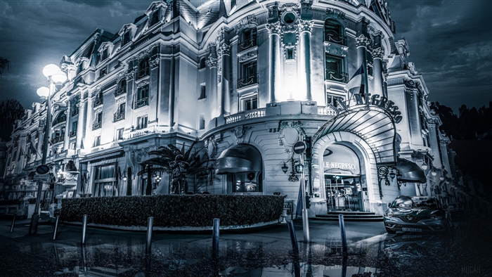 Le Negresco building at night with puddles
