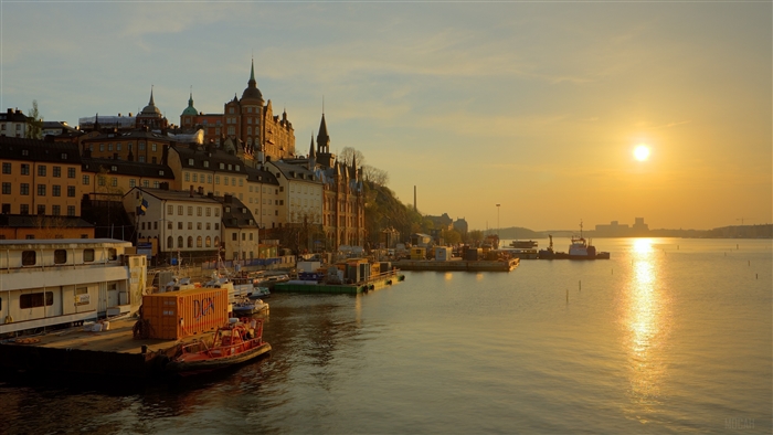 Stockholm waterfront at sunrise with boats and buildings