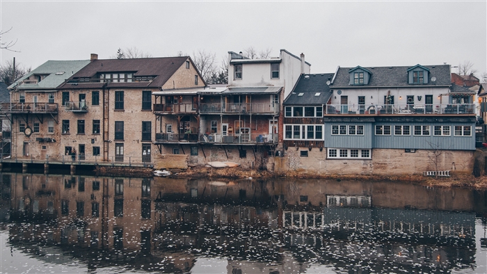 Buildings on a river with reflections 4K