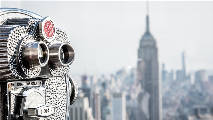 Binoculars overlooking New York City skyline with Empire State Building