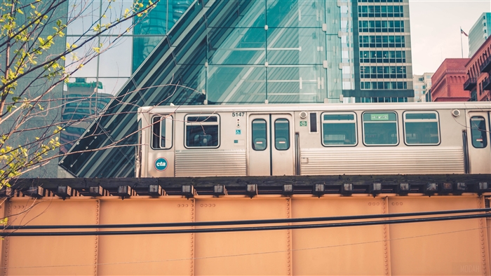 Chicago CTA train on an elevated track with modern buildings