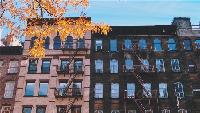 Apartment buildings with fire escapes in autumn