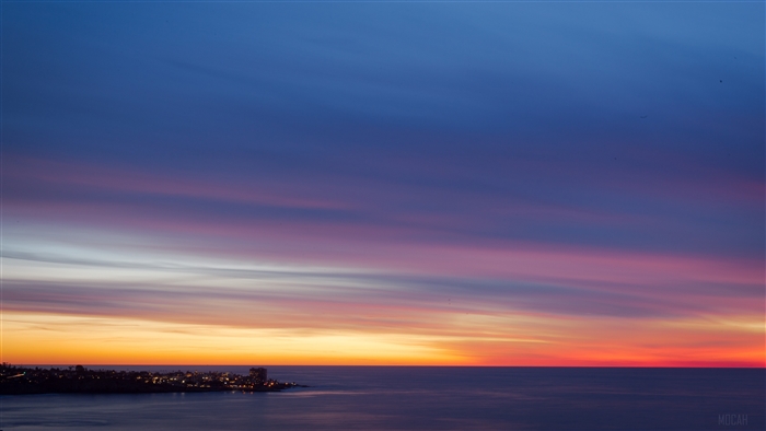 Sunset over a coastal city 4K