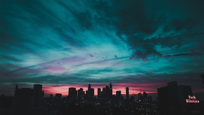 City skyline at sunset with colorful clouds