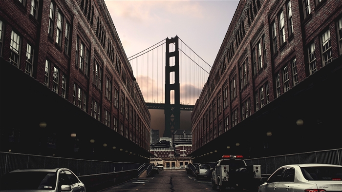 Golden Gate Bridge between brick buildings