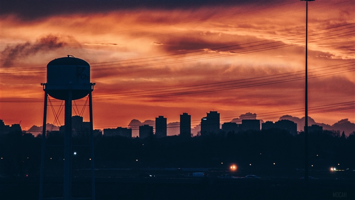 City skyline with water tower at sunset 4K
