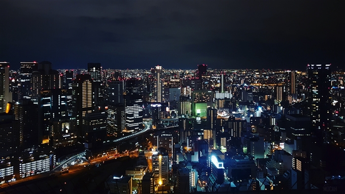 Night city skyline with illuminated buildings 4K