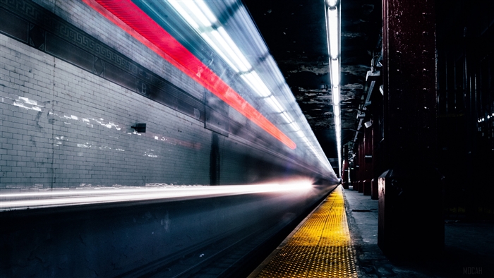 Train light trails on a subway platform