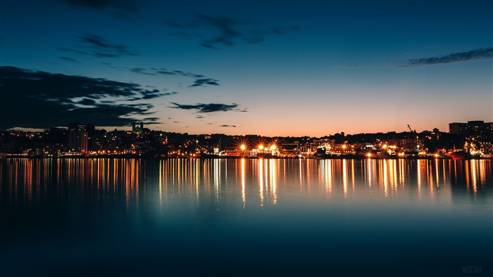 City skyline at night reflected in the water