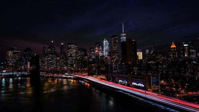 New York City skyline at night with bridge
