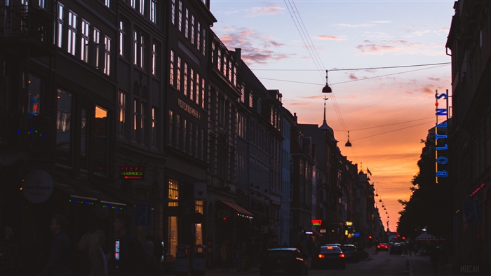 City street at sunset with buildings and cars