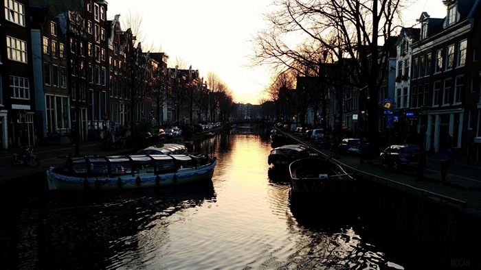 Canal boats at sunset in Amsterdam 4K