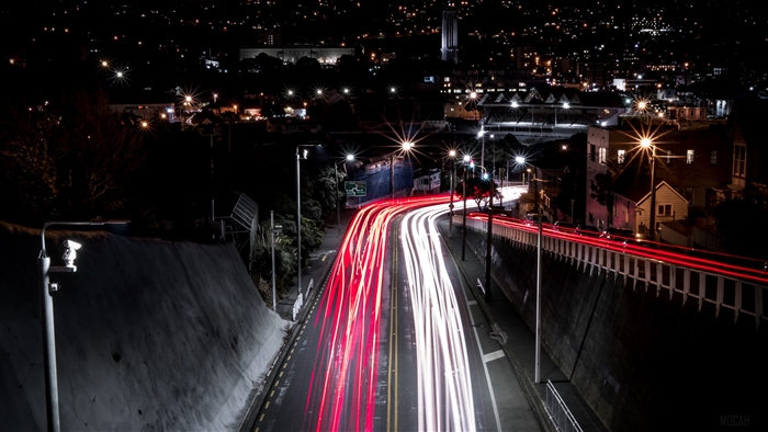 City at night with light trails on road 4K