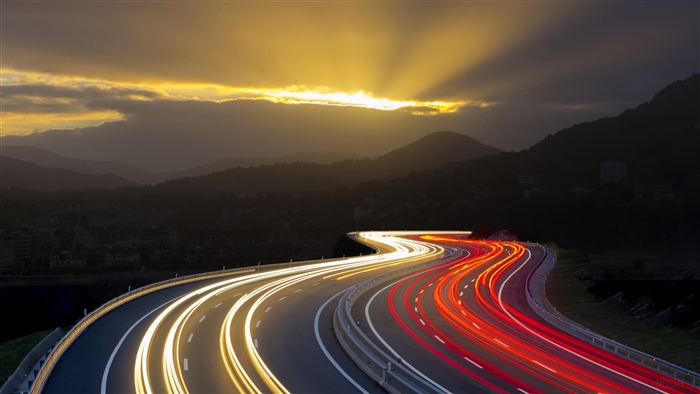 Glowing Road Turn at Night with Mountains 4K
