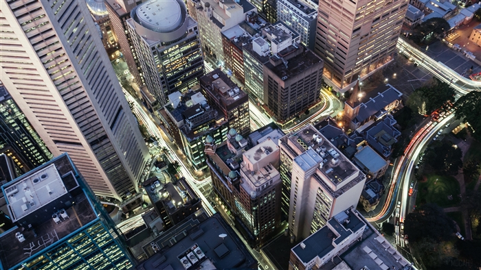 Aerial view of a city at night with light trails