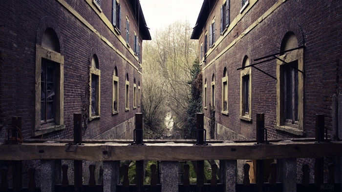 Two brick buildings with a canal in between