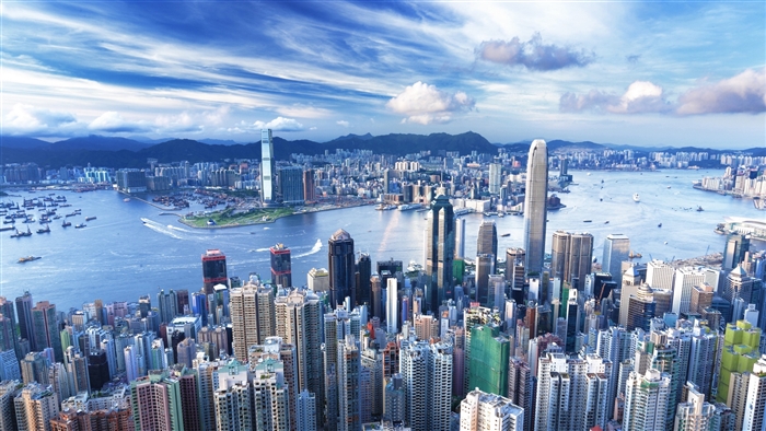 Hong Kong cityscape with Victoria Harbour and mountains 4K