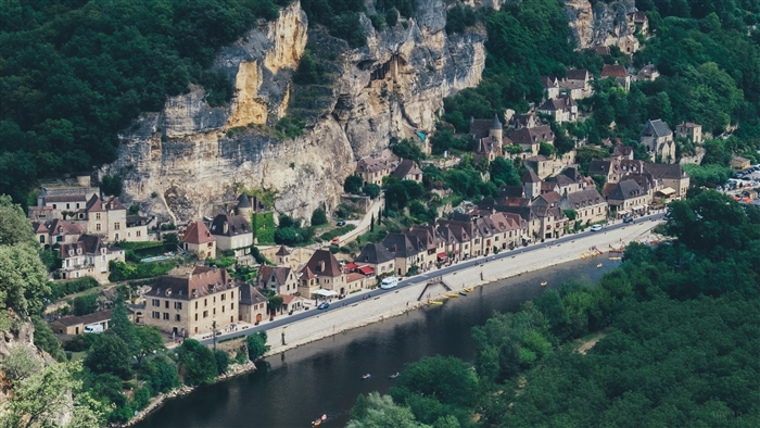 Village on a cliffside by a river in France