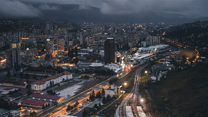 Night city view with buildings and railway 4K