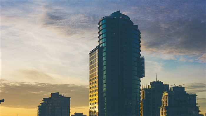 Modern skyscraper against a cloudy evening sky
