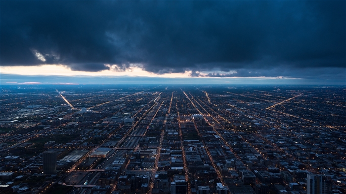 Night city view from above with clouds