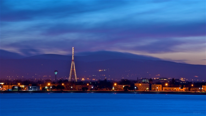 Dublin skyline with tower and mountains at dusk 4K
