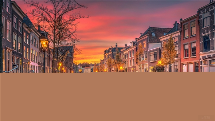 Street with canal and buildings at sunset in Netherlands 4K