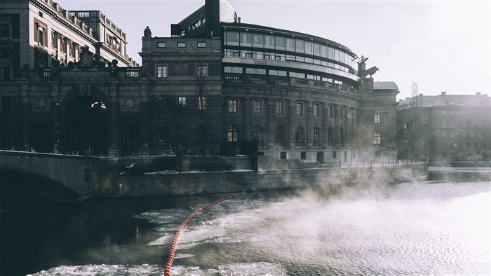 Building by the river with ice and steam