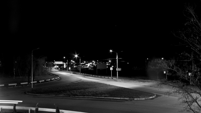 Night road with street lights and car light trails 4K