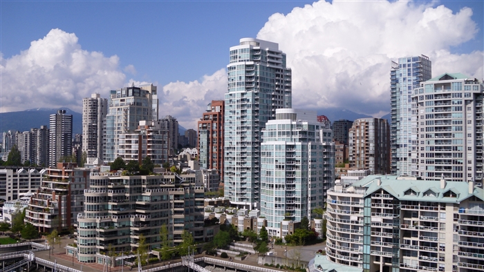 Vancouver cityscape with modern buildings and mountains