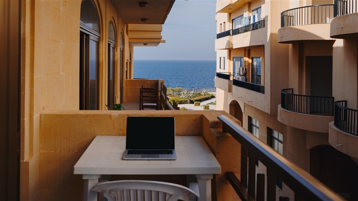 Laptop on a balcony overlooking the sea in Malta 4K