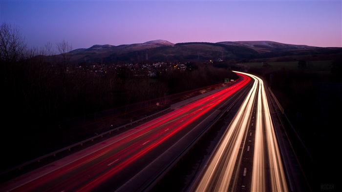 Long exposure highway at night with mountains