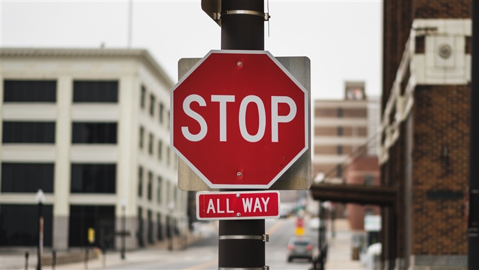 Stop All Way Sign on Pillar