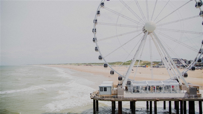 Ferris wheel attraction on a beach 4K