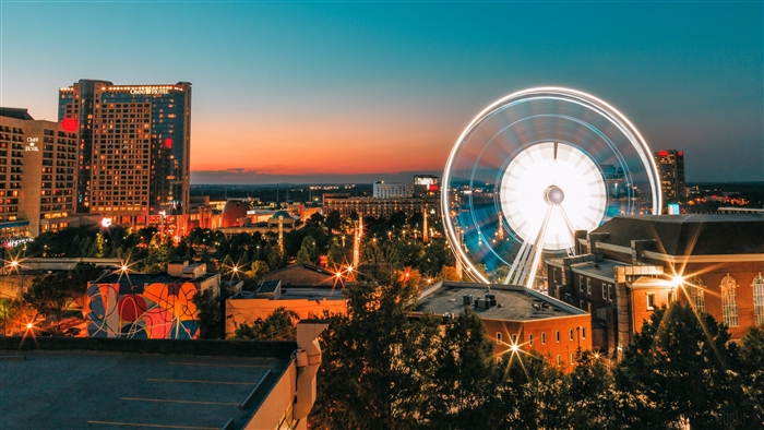 City skyline with Ferris wheel at dusk 4K