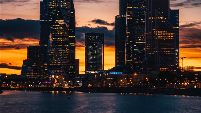 Skyscrapers at sunset over a city river